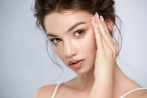 Woman showcasing lifted brows after transfollicular brow lift